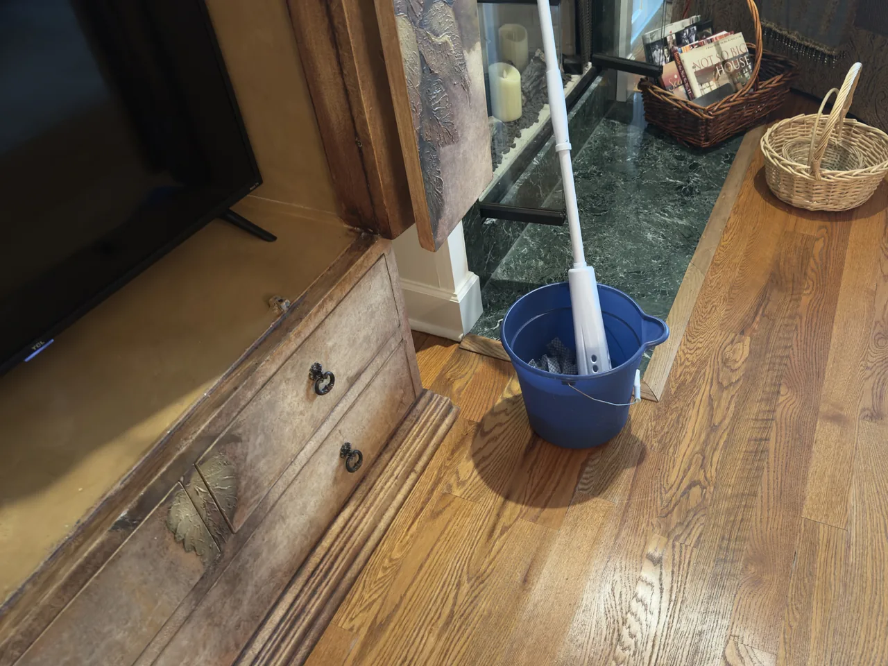 Sandra's own mop and bucket on a freshly cleaned hardwood floor